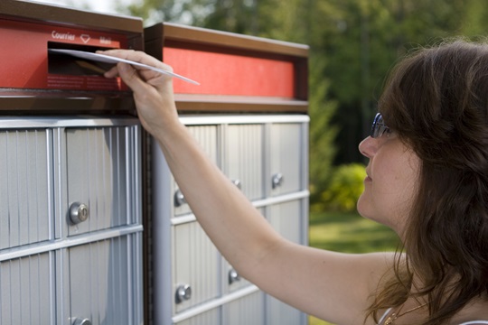 A woman mailing a letter.
