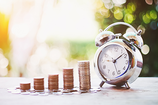 Pennies next to an alarm clock.