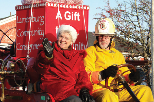 Cheryl Lamerson and husband Will Brooks greet the crowds while aboard an antique fire truck during last November’s Lunenburg Santa Parade.