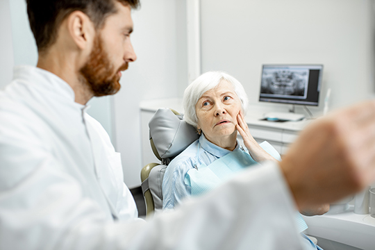 Senior lady having a consultation with a dentist.