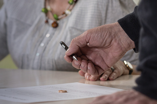 Signing a document.