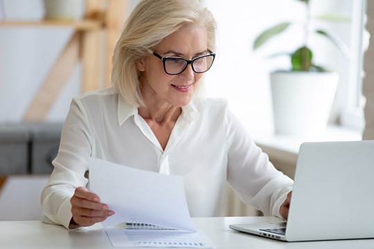 Are you ready to transition from work to retirement? Adult woman at computer.
