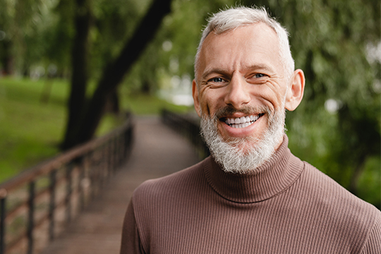 Volunteering can be good for your health! Volunteer smiling outdoors.