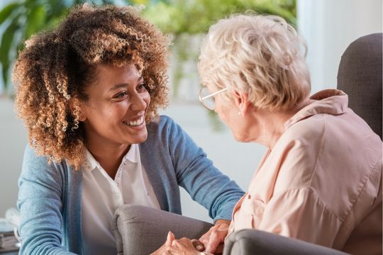 Woman with smiling caregiver.