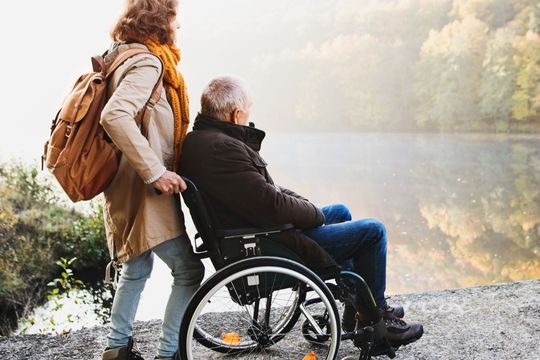 Home caregiver assisting a woman.