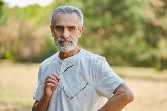 Adult man standing outside.