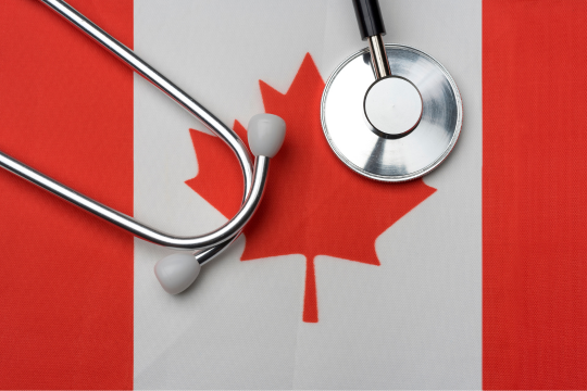 Stethoscope sitting on a Canadian flag.