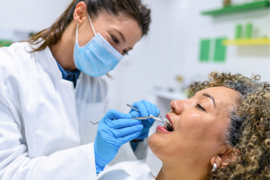 Dentist with adult patient.