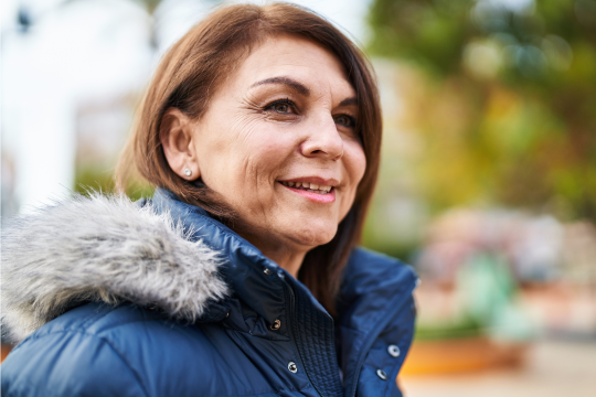 Take action as an advocacy program officer! Smiling adult woman in winter coat.