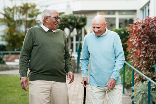Two adult friends talking outdoors.