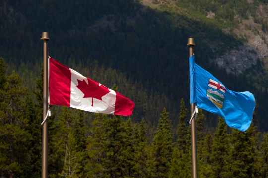 Association shares survey results on Alberta’s proposal to leave CPP. Flags of Alberta and Canada side by side.