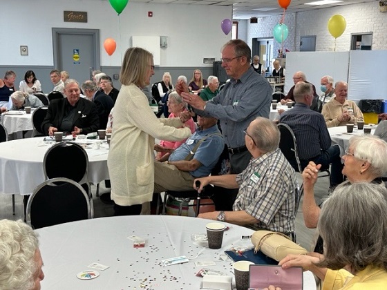 Noreen Campbell, Treasurer presenting a gift card to our first winner.