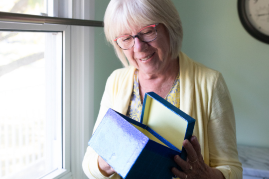 Anne Bisson looking at her box.