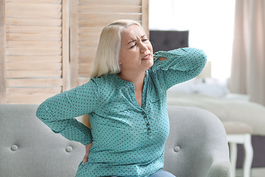 A woman experiencing back pain