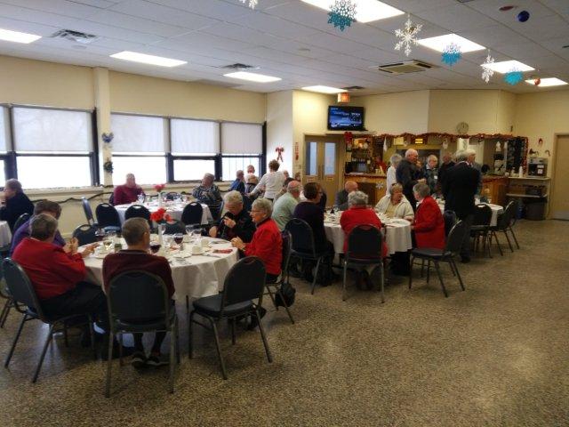 A group of people gathering at tables for a holiday banquet Federal Retirees members seated for a banquet