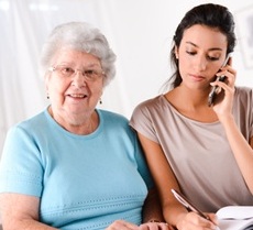 Senior woman with younger woman on the phone.