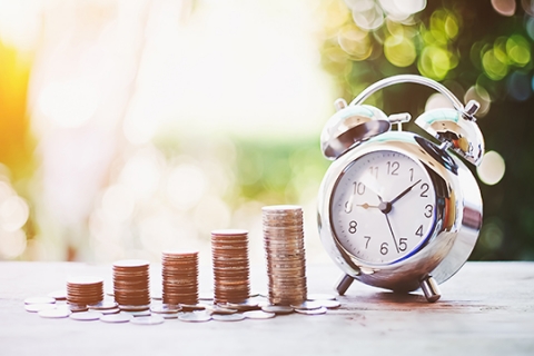 Pennies next to an alarm clock. Pennies next to an alarm clock.
