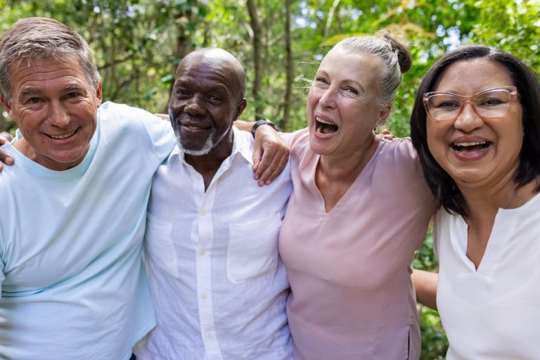 Group of smiling older adults standing together.