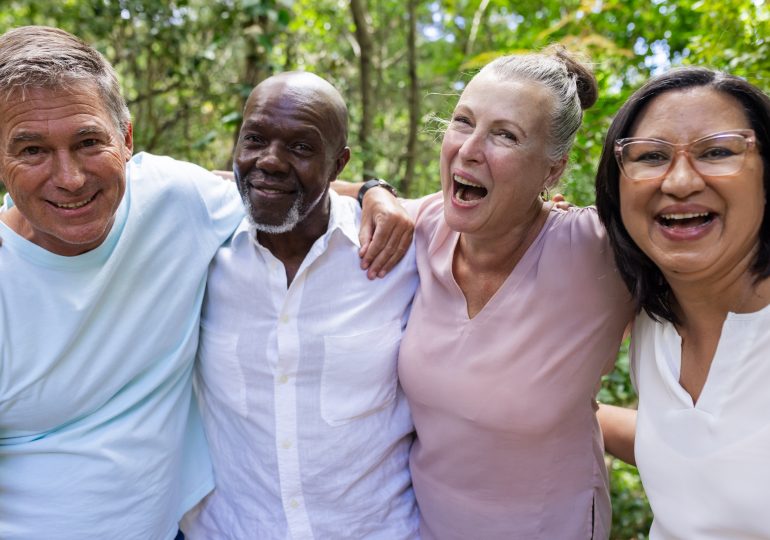 Group of smiling older adults standing together.