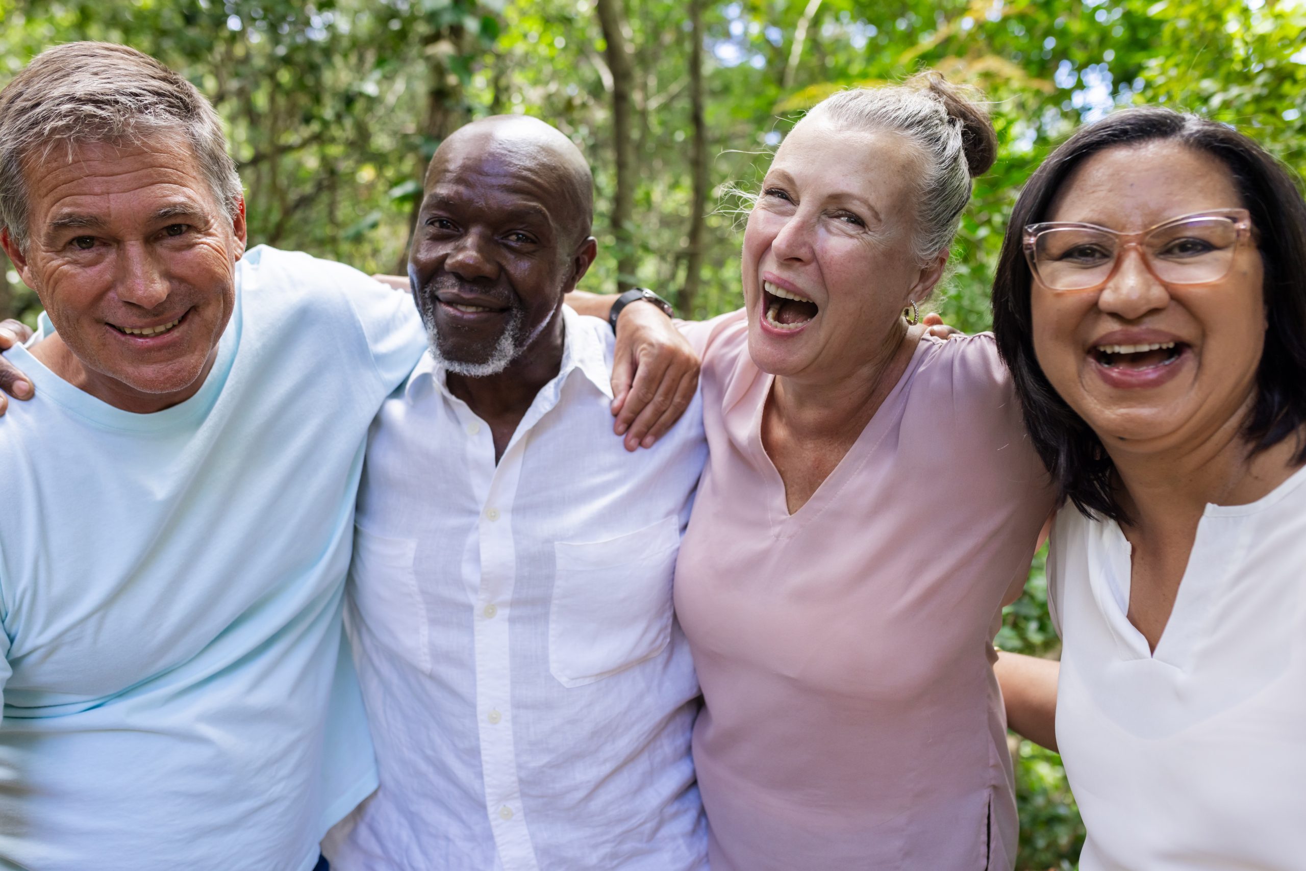 Group of smiling older adults standing together.