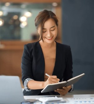 Woman writing in a notebook.