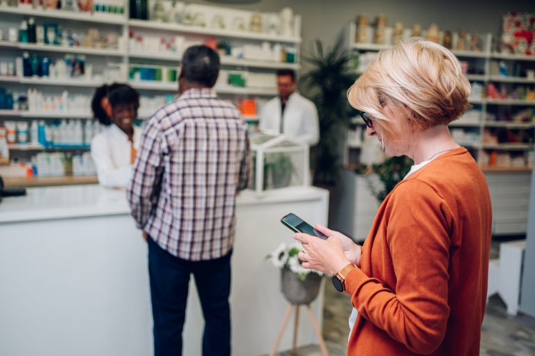 Adult woman customer standing in a pharmacy.