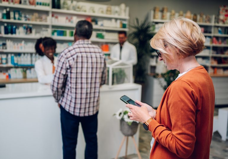 Adult woman customer standing in a pharmacy.