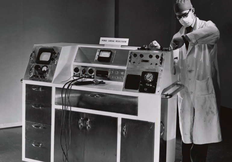 The Mobile Cardiac Resuscitator designed by Canadian engineer John Hopps. Alternate: Doctor examining x-ray image of chest with pacemaker implant.