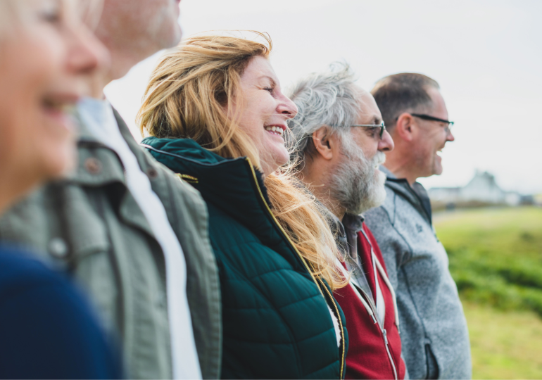 Older adults standing together and looking ahead.