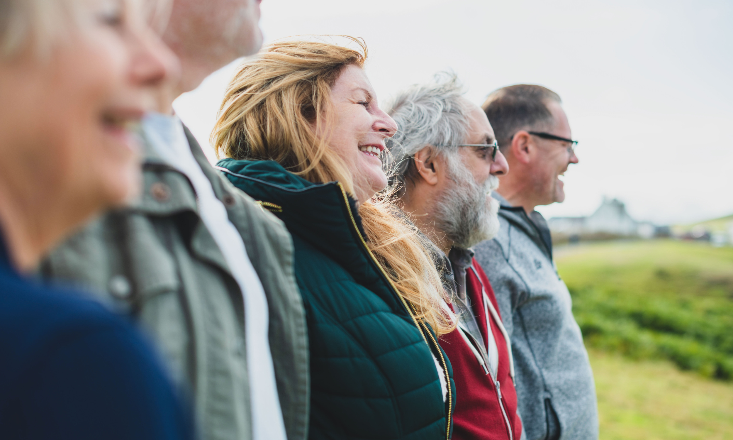 Older adults standing together and looking ahead.