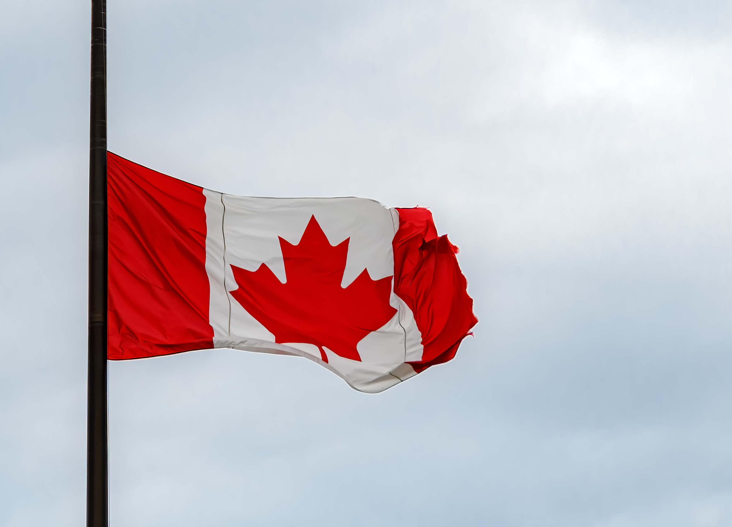 Canadian flag at half-mast.